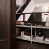 Modern shelving unit with sleek silver accents, white surfaces, and rich dark wood contrasting with minimal decorative elements.