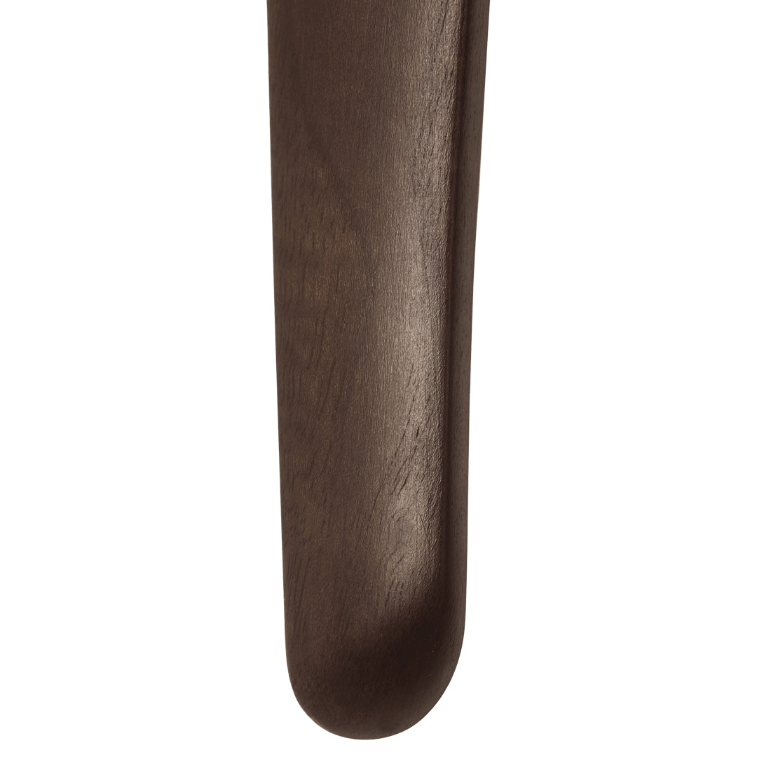 Dark brown wooden spoon with a smooth finish and rounded edge, showcasing natural wood grain patterns.