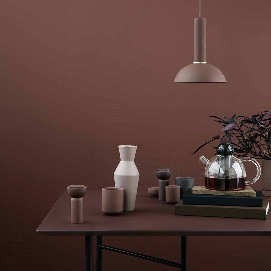 Neutral-toned decor featuring clay, beige, and gray vases against a warm brown backdrop. Modern and minimalist design.