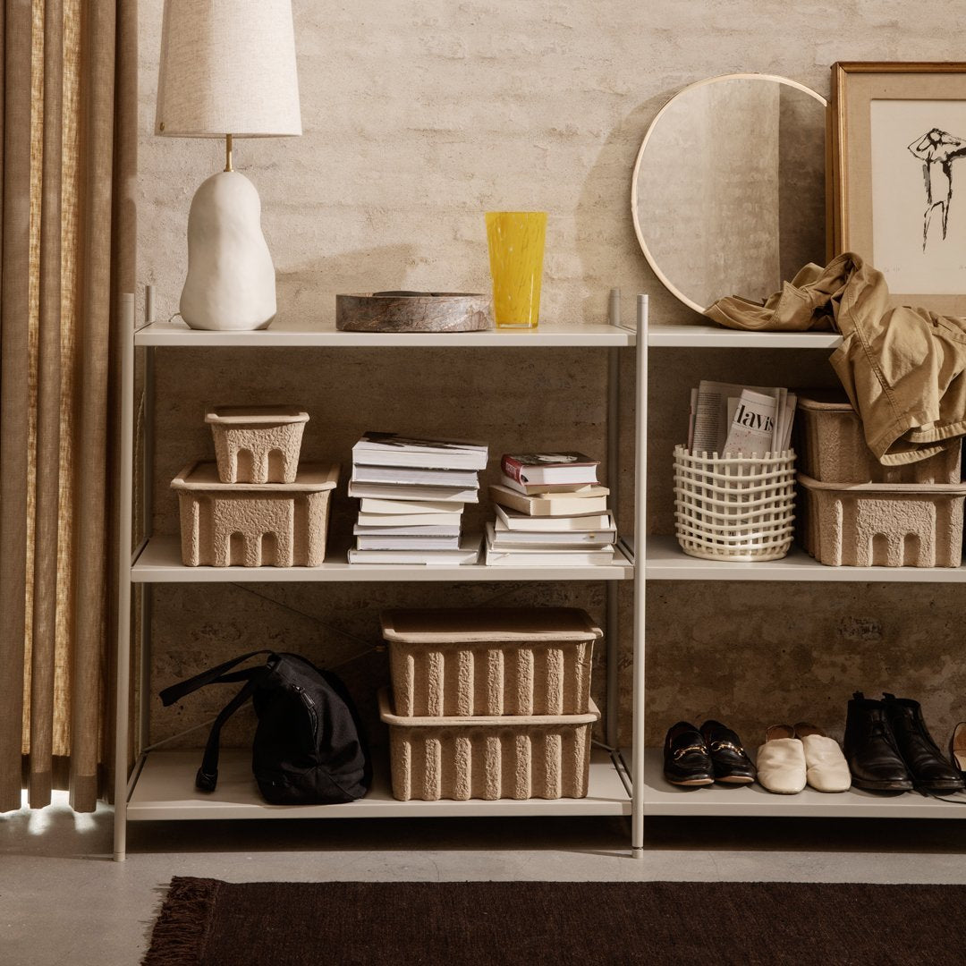 Neutral-toned shelving unit with textured baskets, showcasing earthy hues and contemporary patterns. Perfect for stylish storage.