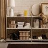 Neutral-toned shelving unit with textured baskets, showcasing earthy hues and contemporary patterns. Perfect for stylish storage.
