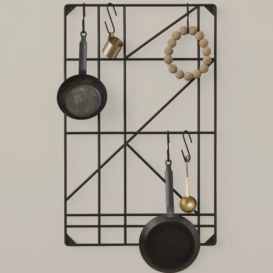 Black geometric wall rack with metal and wooden accents, featuring circular and linear patterns.