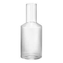 Clear glass vase with vertical ribbed pattern, showcasing a modern and sleek design. Ideal for elegant decor.
