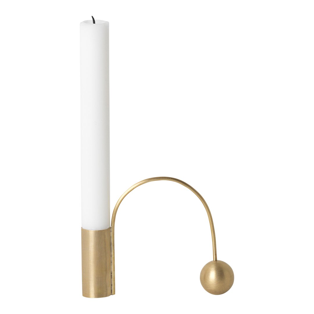 White candle in a gold holder featuring a sleek modern design with curved lines and a spherical accent.