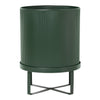 Green ribbed planter with sleek metal stand, perfect for adding a modern touch to any decor.