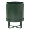 Dark green ribbed planter with a sleek black stand, featuring a modern, minimalist design.