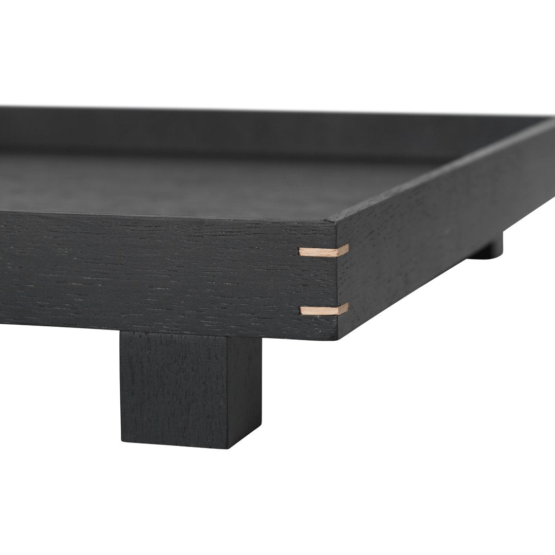 Black wooden tray with a sleek design and natural wood accents at the joints. Perfect for minimalist decor.