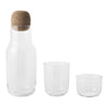 Clear glass carafe with cork lid and two matching glasses, showcasing a minimalist design and transparent finish.