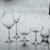 Set of five elegant clear glassware with varying shapes and sizes, showcasing sleek, modern designs.