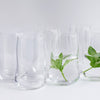Clear glass tumblers with smooth curvature, showcasing fresh mint leaves in water for a refreshing look.