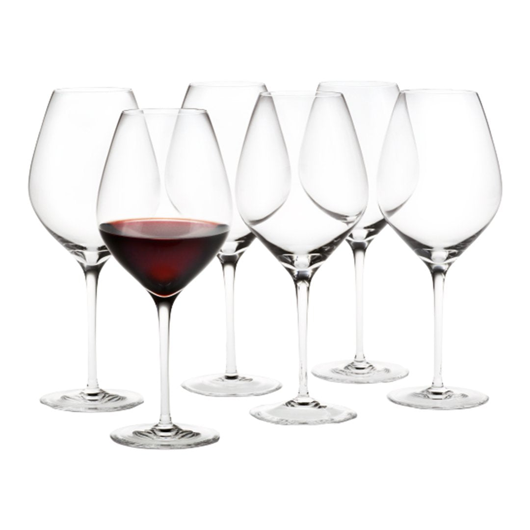 Set of six crystal wine glasses with a single glass filled with rich red wine, showcasing elegant design and clarity.