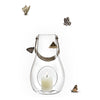 Clear glass lantern with a silver handle, featuring a white candle inside and a whimsical butterfly pattern.