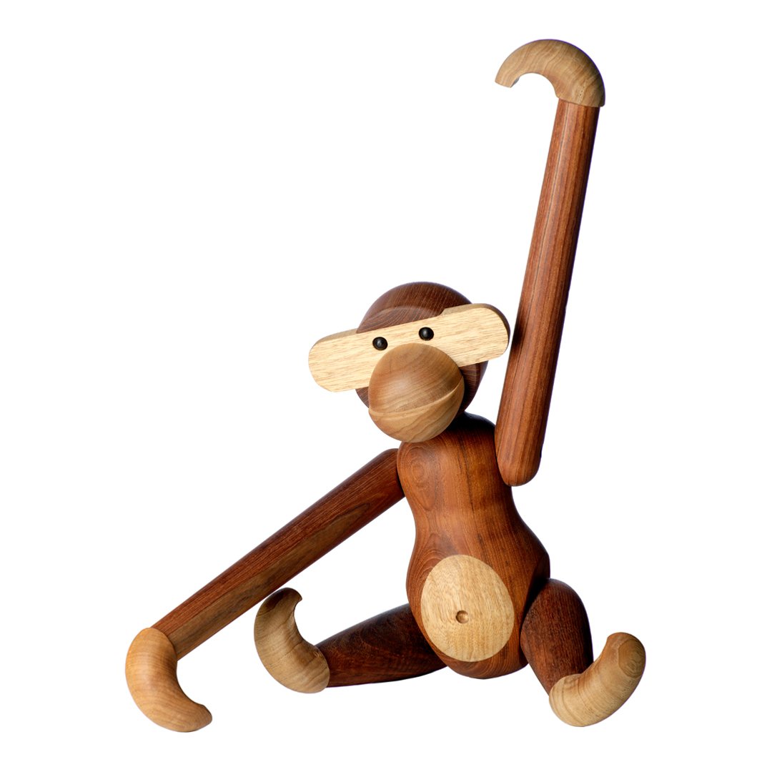 Wooden monkey figurine in rich brown tones with light wood accents. Playful design features curved arms and rounded shapes.