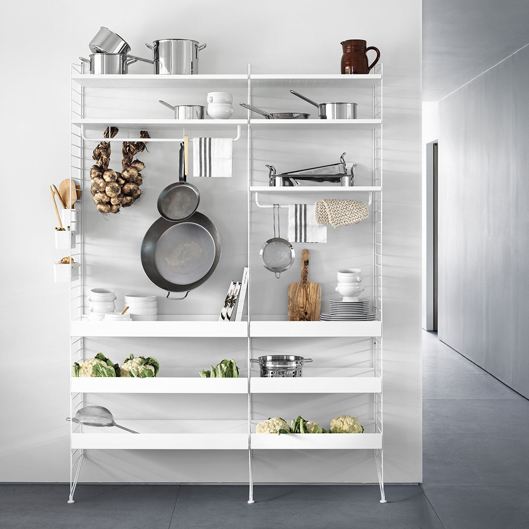White metal shelving unit with sleek lines and an organized display of kitchenware against a light gray background.