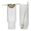 Clear ribbed glass cocktail glasses with gold spoon and stirrer accents, ideal for elegant drinks and entertaining.