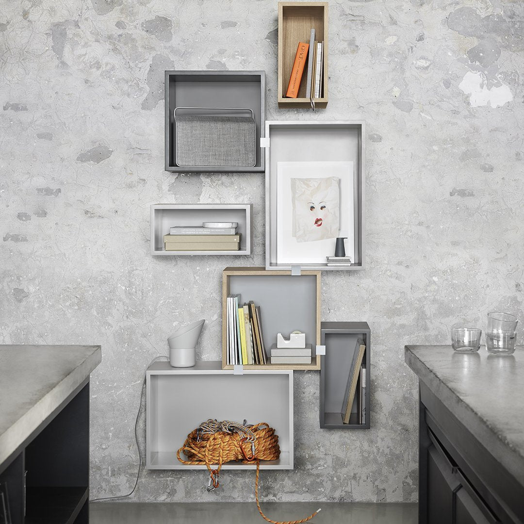 Modern wall shelves in gray and natural wood, featuring a mix of square and rectangular patterns.