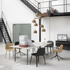 Modern dining space featuring beige, black, and natural wood tones with minimalist design and soft textures.