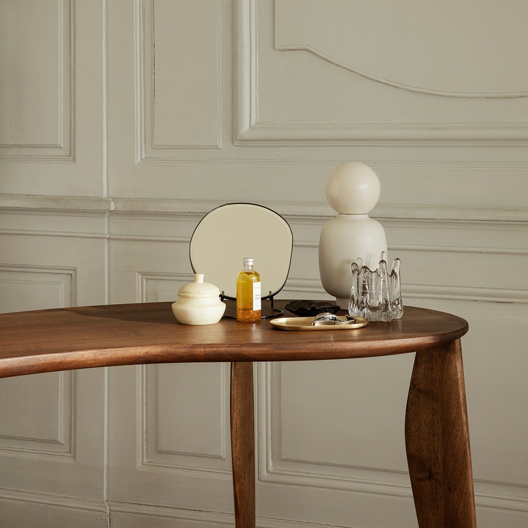 Wooden table with neutral tones, cream and amber accents, featuring geometric patterns and elegant shapes.
