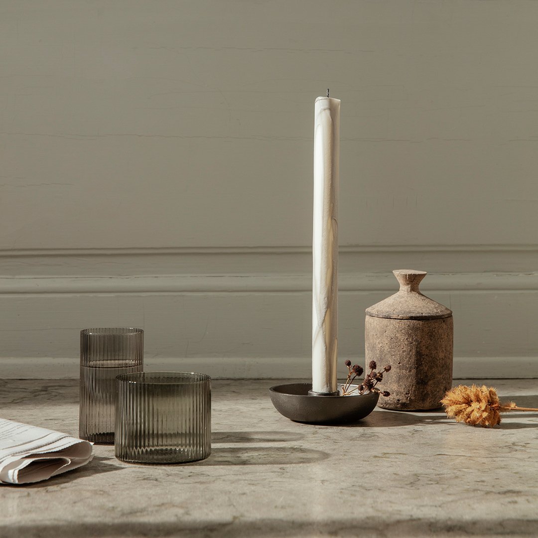 "Neutral tones with textured glass and a rustic clay vase, featuring soft earth colors and subtle patterns."