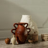 "Set of earthy-toned vases in terracotta, white, and light beige with varied textures and organic shapes."