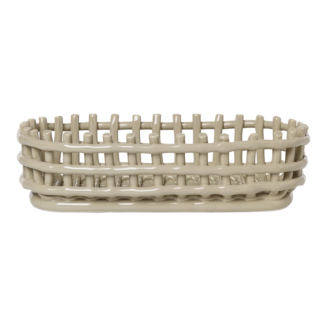 Light beige oval basket with a woven pattern and elevated edge for stylish storage. Perfect for home organization.