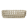 Light beige oval basket with a woven pattern and elevated edge for stylish storage. Perfect for home organization.