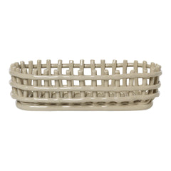 Light beige oval basket with a woven pattern and elevated edge for stylish storage. Perfect for home organization.