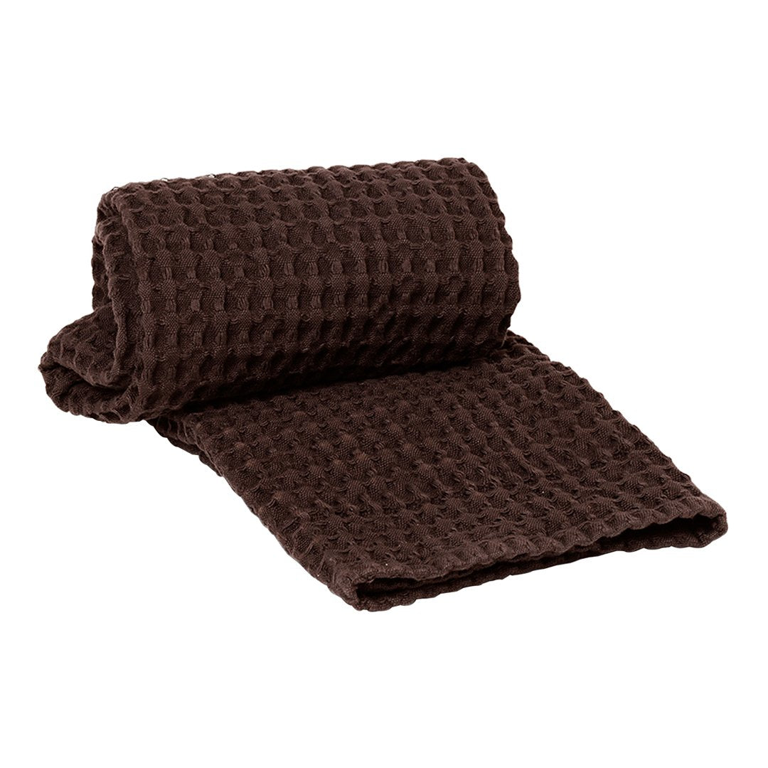 Brown textured blanket featuring a cozy waffle pattern, perfect for adding warmth and style to any space.