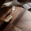 Round wooden table with rich dark brown tones and a sunburst pattern, featuring subtle variations and a natural finish.