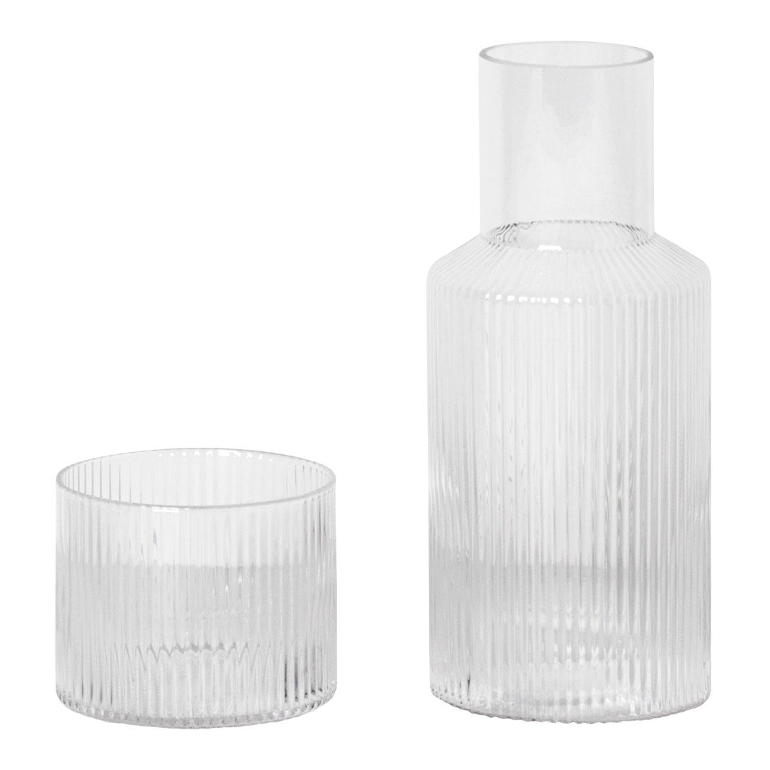 Clear glass carafe and glass with ribbed pattern, showcasing a minimalist and elegant design.
