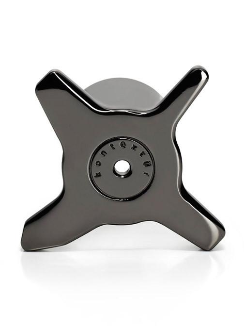 Shiny black accessory with a sleek, cross-shaped design and subtle circular pattern in the center.