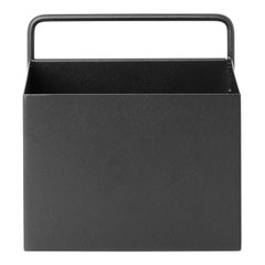 Black metal storage box with a sleek, minimalistic design and a sturdy handle. Perfect for modern decor.
